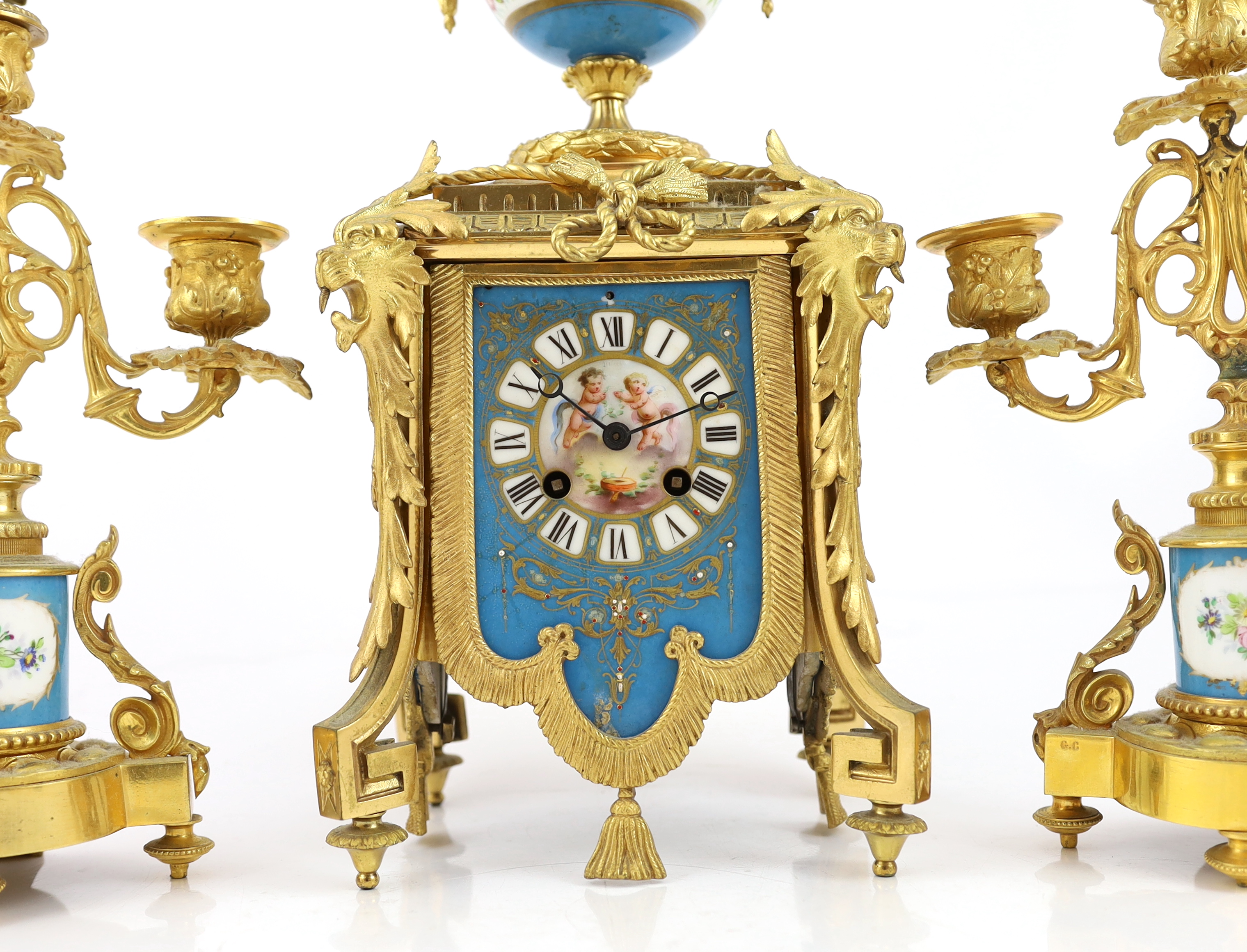 A 19th century French ormolu and Sevres style porcelain clock garniture, clock 19cm wide, 15cm deep, 37cm high candelabra 19cm wide, 30.5cm high